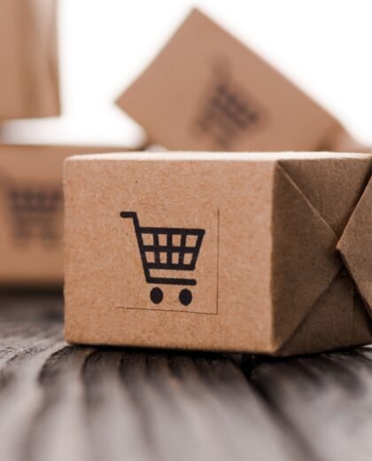 close up of small carton boxes on table isolated on white, e-commerce concept close up of small carton boxes on table isolated on white, e-commerce concept
