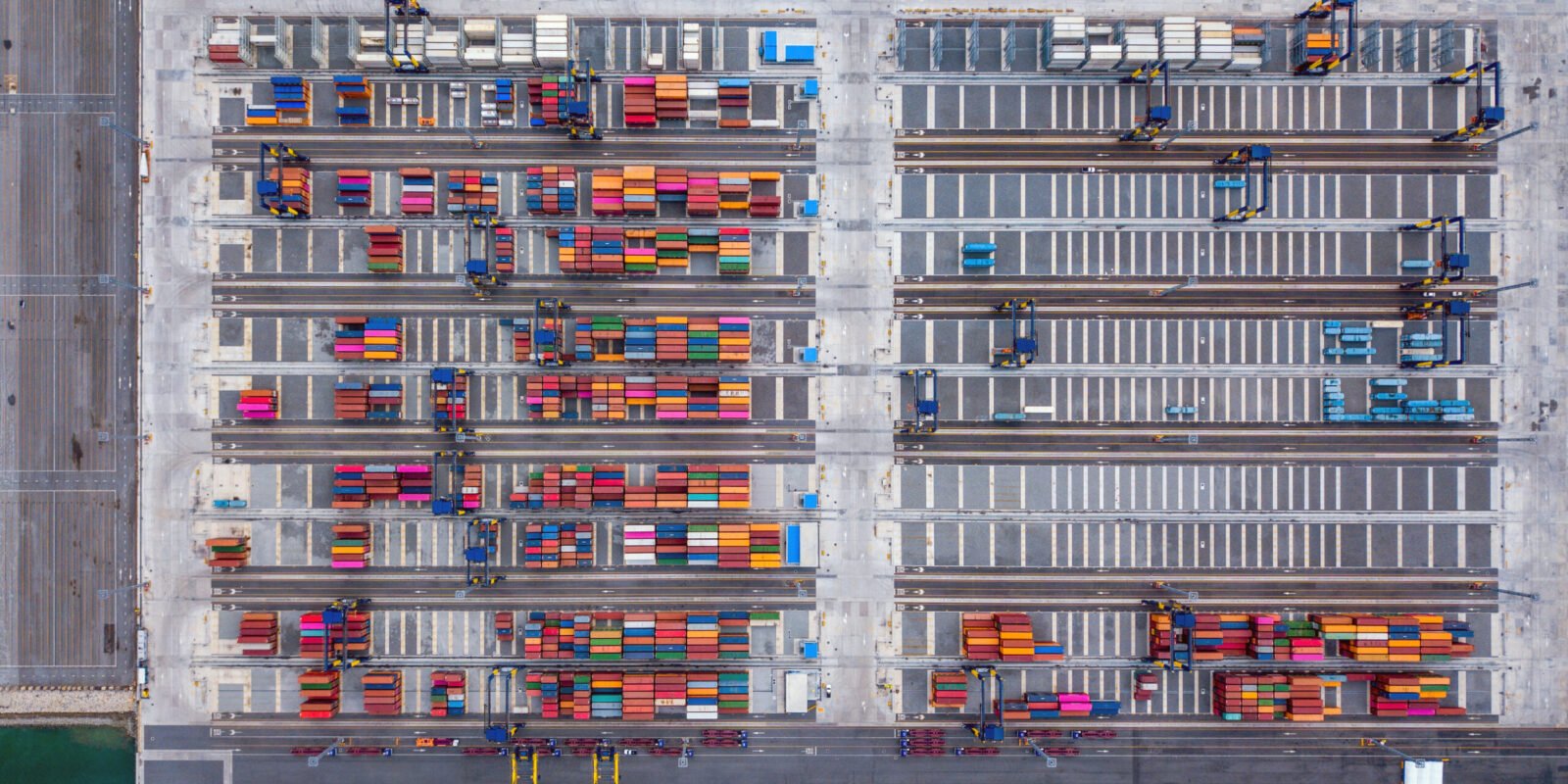Aerial top view of container cargo ship in the export and import business and logistics international goods in urban city. Shipping to the harbor by crane in Laem Chabang, Chon Buri, Thailand