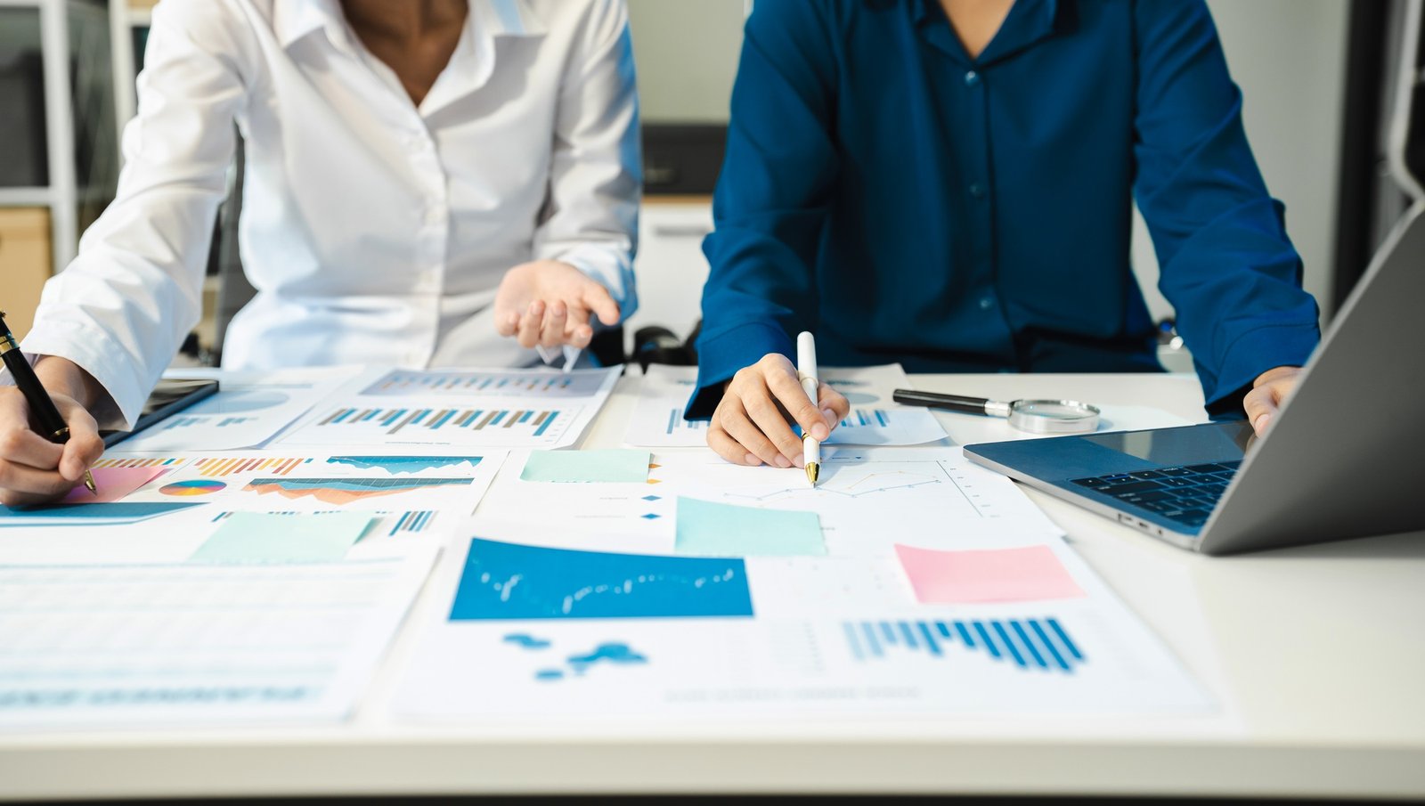financial advisor showing plan of investment to clients in the consultancy.
