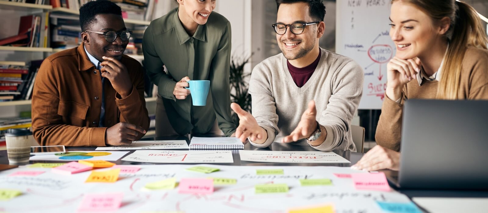 Happy creative marketing team working on new business project in the office. Happy creative marketing team working on new business project in the office.